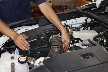 auto mechanic changing car engine