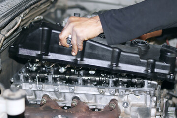 Obraz na płótnie Canvas auto mechanic changing car engine