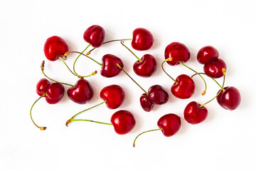 Fototapeta na wymiar Scattered cherry berries on a white background horizontal orientation