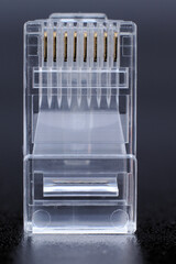 Telecommunications equipment connections, RJ 45 cable connector on a black background. macro