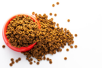 plastic bowl full with dry dog food isolated on white background. Top view grain pet food with copy space of text design. Above or Top view. food texture banner..