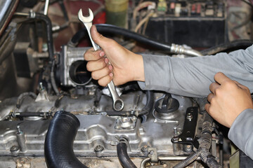 Obraz premium The mechanic is checking the engine.