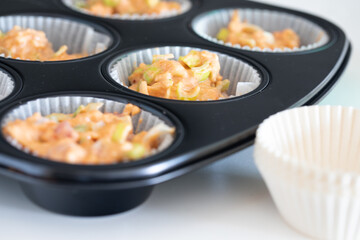 Making homemade cheese muffins, pouring dough to muffin tray. savory muffin. home made. healthy food. baking at home