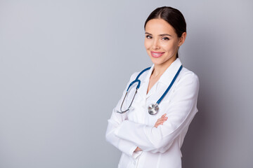 Fototapeta premium Profile photo of attractive cheerful family doctor doc toothy smiling experienced skilled professional arms crossed wear medical uniform lab coat stethoscope isolated grey background