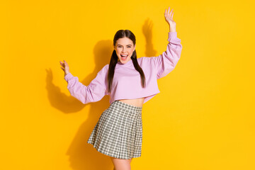 Portrait of candid funny teen girl raise hands imagine she dance in night club wear good look...
