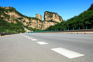 Empty highway, blue sky and white clouds landscape