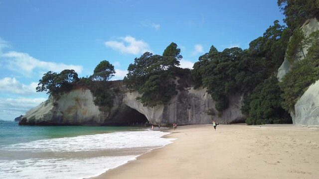  4k right to left pan motion of the rock formation know as Cathedral Cove on the coromandel Peninsula,tourist destination which became famous because of a movie film location,north island,New Zealand