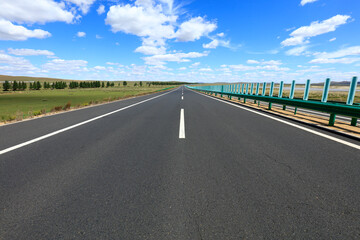 Empty highway, blue sky and white clouds landscape