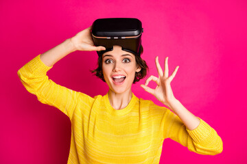 Close-up portrait of her she nice attractive lovely pretty cheerful cheery girl wearing cyber space digital device showing ok-sign isolated on bright vivid shine vibrant pink fuchsia color background