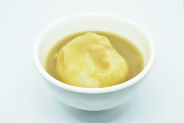 mashed potato dressing gravy sauce in cup on white background