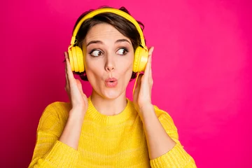 Deurstickers Portrait of astonished funny crazy girl have yellow headset listen unbelievable music impressed look copyspace wear jumper isolated over bright color background © deagreez