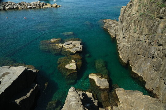 Blue sea and cliff in Riomaggiore, Cinque Terre. Royalty free photos.