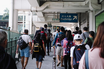 People walk along the star Ferry pier in Hong Kong