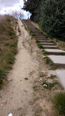 Fototapeta na wymiar steep sandy slope with wooden stairs