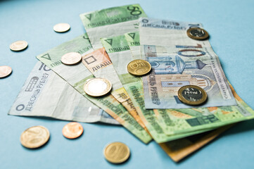 Fototapeta premium Belarusian rubles and coins on a colored background