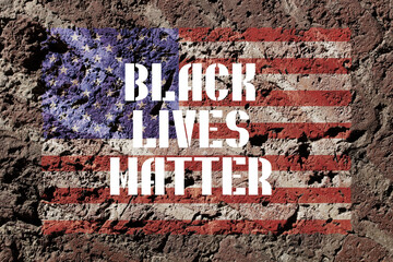 Inscription black lives matter on brick wall with American flag. Anti-racism and police violence...