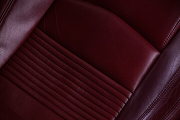 Close up of a dark red leather car seat