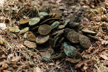 Real treasure with copper coins. Discovery, treasure hunting, digging, metal detection concept.