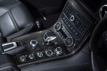 Obraz na płótnie Canvas Carbon fiber control buttons in luxurious car interior