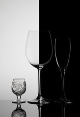 Three glass goblets on a black white background