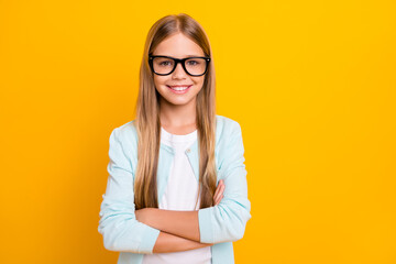 Photo of beautiful pretty little blond lady hold arms crossed diligent student pupil 1 september school girl wear specs casual shirt isolated yellow bright color background