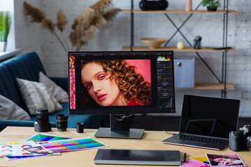 Graphic designer workplace in photo studio. Camera, graphic drawing tablet, laptop,monitor, and color palette. Equipment for retoucher. Creative agency.