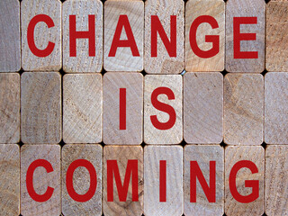 Wooden blocks form the words 'change is coming'. Beautiful wooden background.