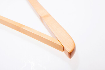 Single white wooden hanger isolated over the white background