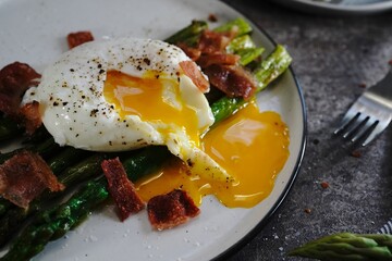 Poached egg with grilled asparagus, selective focus