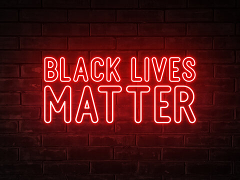Black lives matter - red neon light word on brick wall background