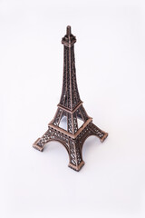 Fototapeta na wymiar Eiffel Tower on an isolated white background. Old metal figurine.