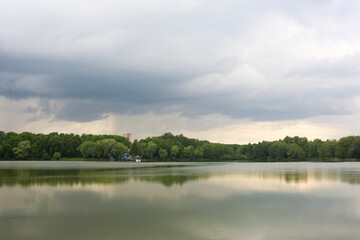 Lake in the background of the park, rainy clouds.
