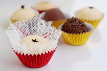 Close up of beijinho, a Brazilian coconut candy made with condensed milk and coconut flakes.
