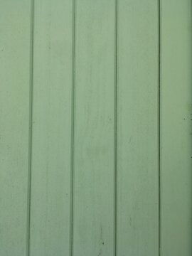 Light sage green painted wooden panels