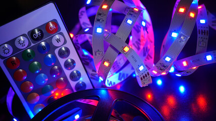 LED strip in purple colors and a control panel for switching colors. Dark background