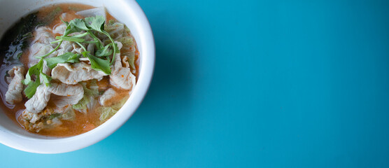 Pork suki in a white cup on a blue background