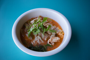 Pork suki in a white cup on a blue background