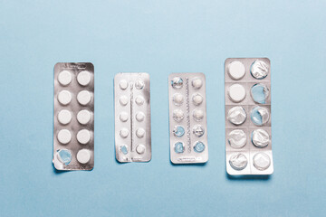 Pills blister pack on a blue background.