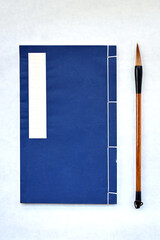 Traditional Chinese calligraphy brush and booklet