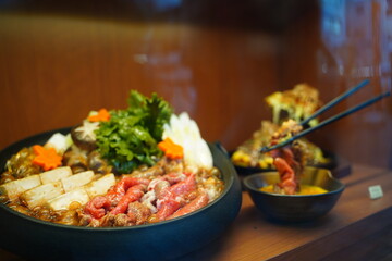 Artificial sample food made from candle wax in a showcase at Kappabashi, Tokyo, Japan. Sukiyaki pot in show window.