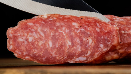 sliced sausage chorizo with a knife closeup. macro shot