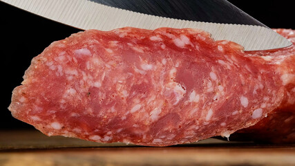 sliced sausage chorizo with a knife closeup. macro shot