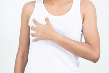 Woman hand checking lumps on her breast for signs of breast cancer on gray background. Healthcare concept.