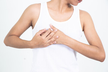 Woman hand checking lumps on her breast for signs of breast cancer on gray background. Healthcare concept.