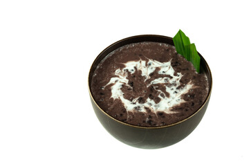 Black Glutinous Rice Porridge or Bubur Pulut Hitam in Malay with coconut milk on white background