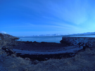 long pier going into blue sea at dawn