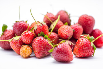 heap of ripe strawberries on white background