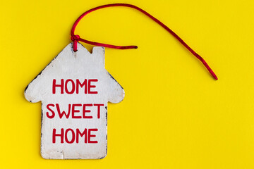 Flat vintage white wooden house with a pipe, a red rope and the inscription home sweet home on a...