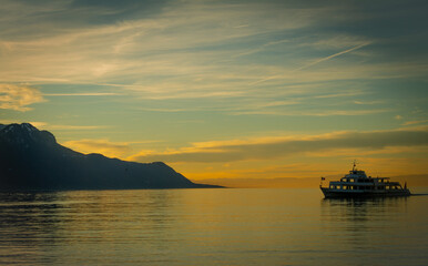 Fototapeta na wymiar Boat on lake Geneva beautiful sunset colors