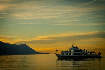 Boat on lake Geneva beautiful sunset colors.